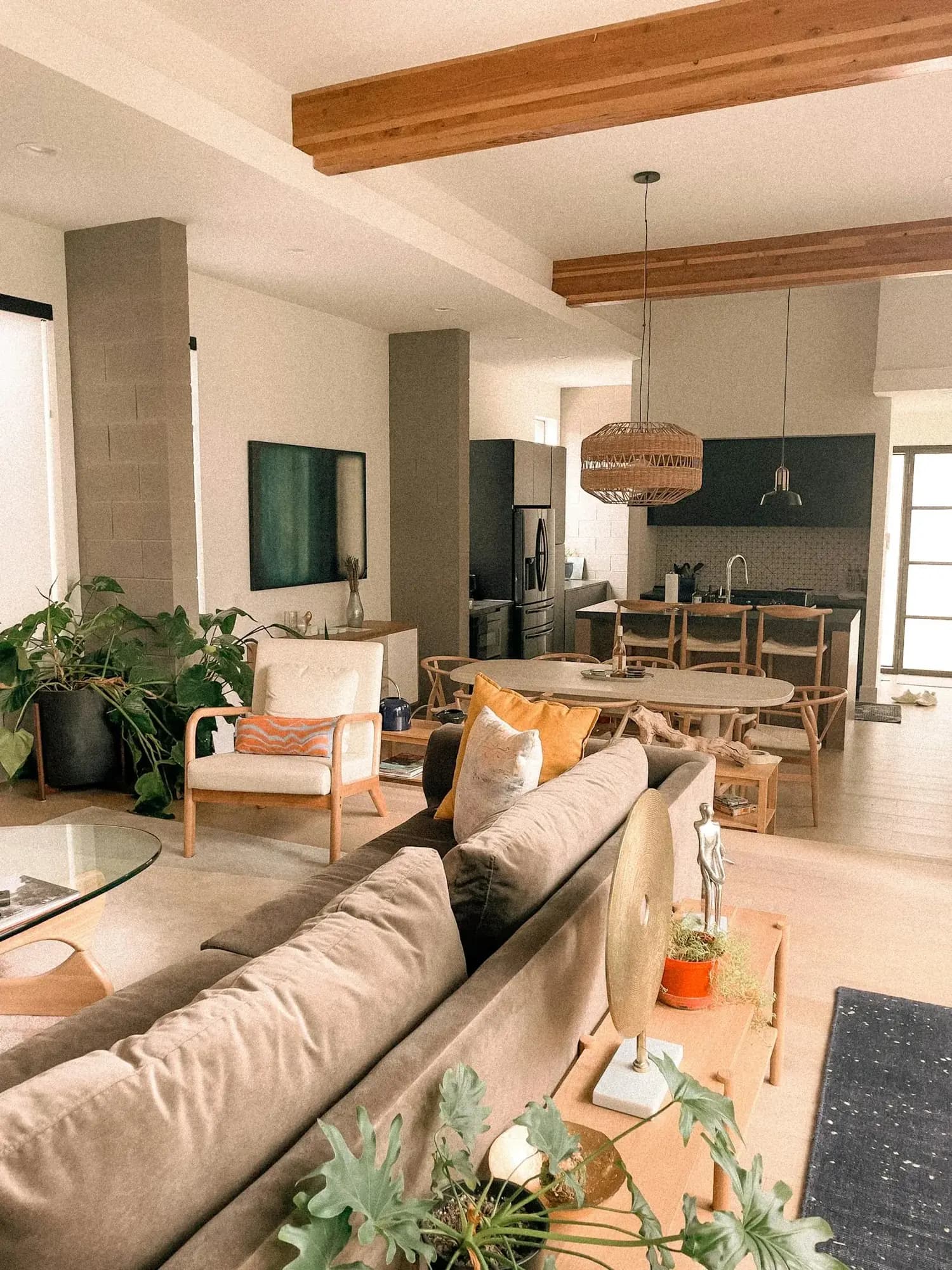 Warm, plant-filled modern interior with natural-wood furniture and soft daylight